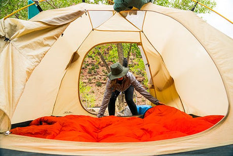 person setting up a tent