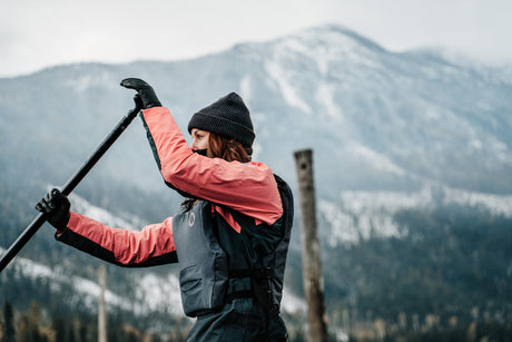 Woman paddling showing Mustang Helix Dry Suit